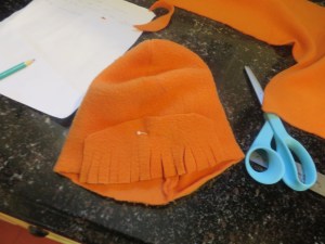 First row of bangs pinned to hat and ready to be sewn.