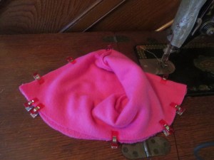 Pink bonnet pieces pinned right-sides together, ready to be sewn. 