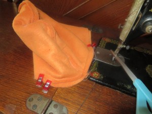 Sewing two hat body pieces together,  skipping over pinned areas for braids and bangs.