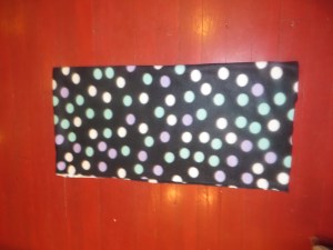 Fleece folded in half, with fold on top where hood will go, and then folded in half horizontally. (Left side is top fold, where hood will attach in this picture.)